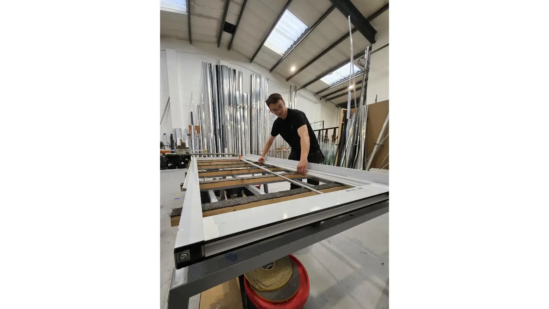 Kingsland fabricator assembling an aluminium frame on the workshop bench in Warrington